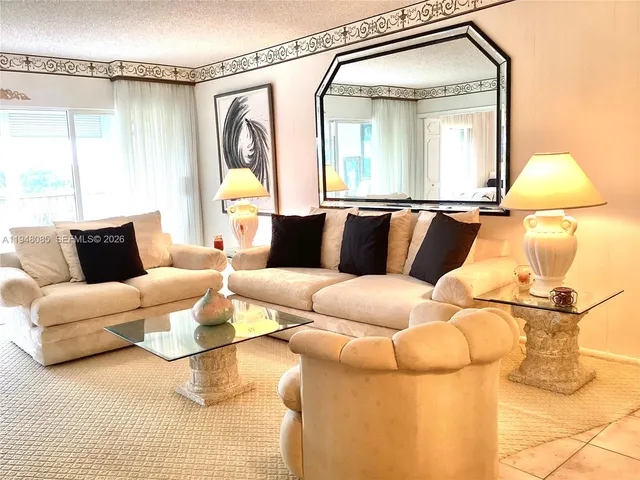 a living room with a large window and furniture