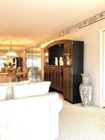 a bedroom with a bed and a flat tv screen on dresser