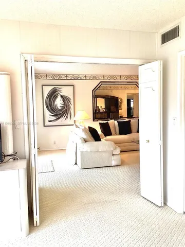 a bedroom with a bed and a night stand