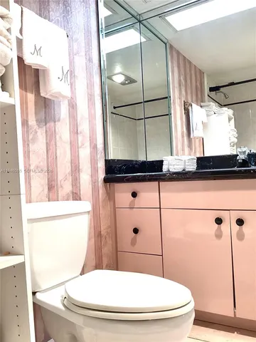 a view of a bedroom with a bed and a window