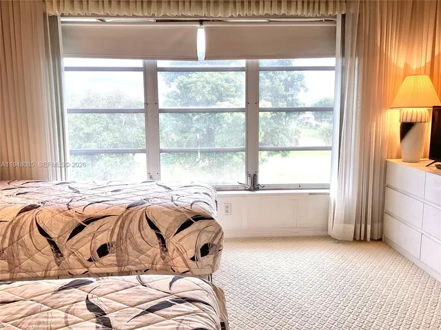 a bathroom with a sink a toilet a mirror and shower