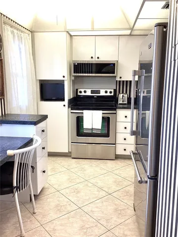 a living room with a couch and a chandelier