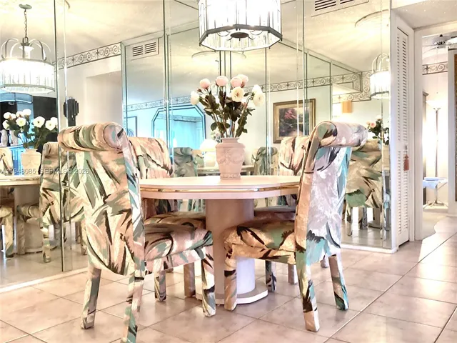 a bedroom with a bed and a large mirror on the dresser