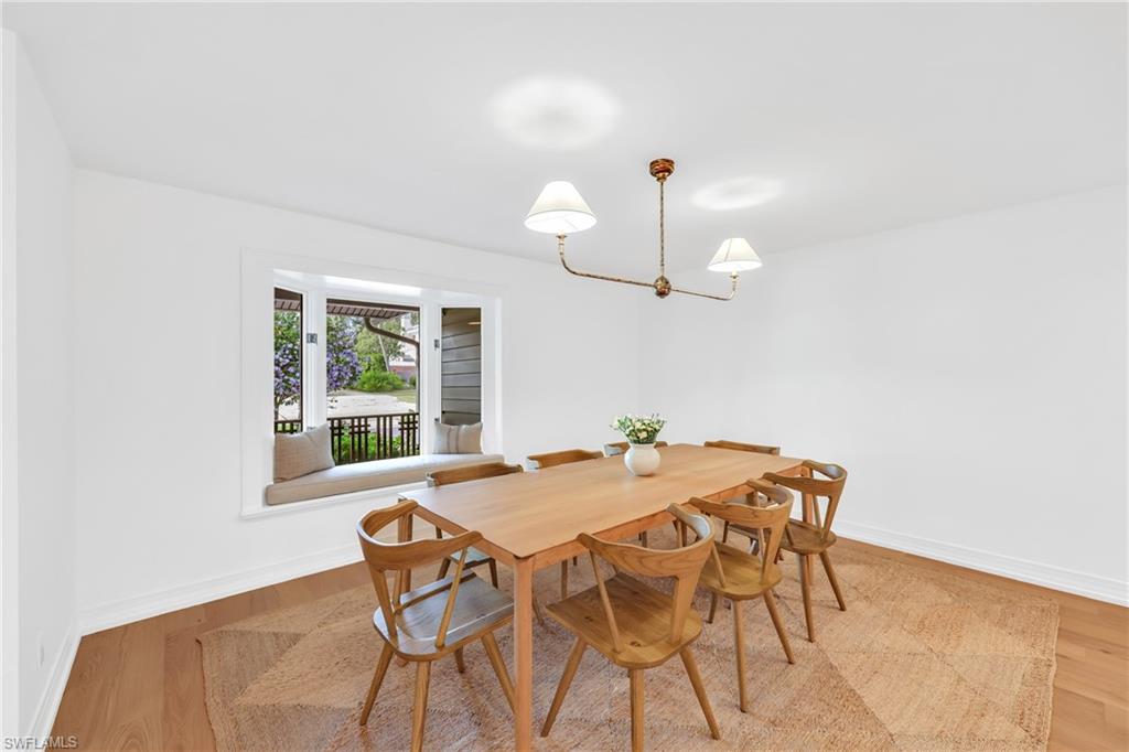 4870 Whispering Pine Way Naples, FL 34103 - Photo 11 of 43 a view of a dining room with furniture and a chandelier