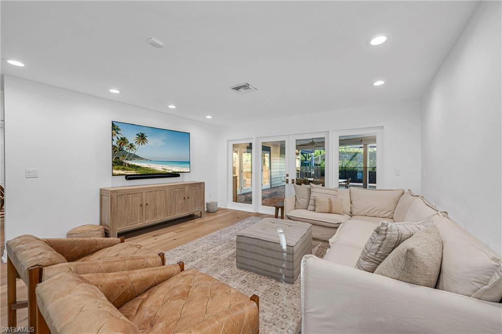 4870 Whispering Pine Way Naples, FL 34103 - Photo 13 of 43 a living room with furniture and a flat screen tv