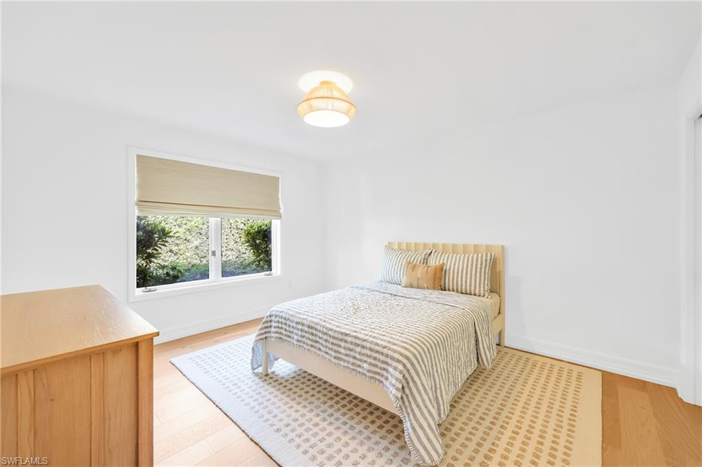 4870 Whispering Pine Way Naples, FL 34103 - Photo 28 of 43 a bedroom with a bed and a window