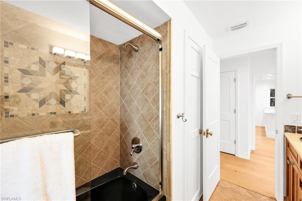 4870 Whispering Pine Way Naples, FL 34103 - Photo 30 of 43 a bathroom with a shower and a sink