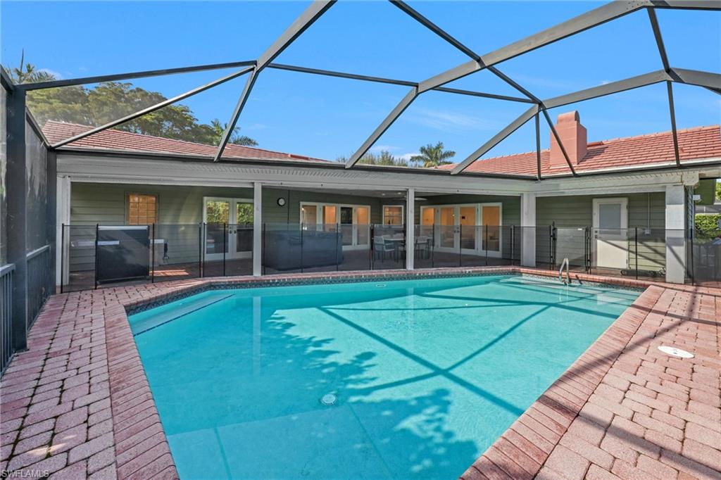 4870 Whispering Pine Way Naples, FL 34103 - Photo 32 of 43 a view of a house with sitting area and a swimming pool