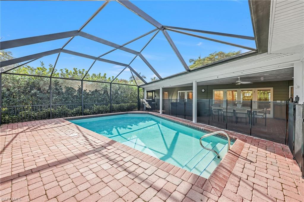 4870 Whispering Pine Way Naples, FL 34103 - Photo 33 of 43 a view of a backyard with a small swimming pool