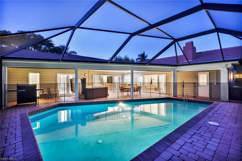 4870 Whispering Pine Way Naples, FL 34103 - Photo 35 of 43 a view of a swimming pool with an outdoor seating