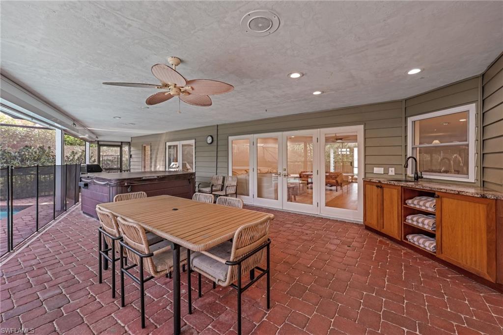 4870 Whispering Pine Way Naples, FL 34103 - Photo 36 of 43 a view of a dining room with furniture window and wooden floor