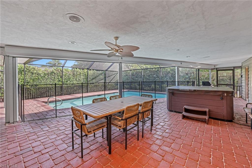 4870 Whispering Pine Way Naples, FL 34103 - Photo 37 of 43 a view of a dining room with furniture wooden floor and chandelier