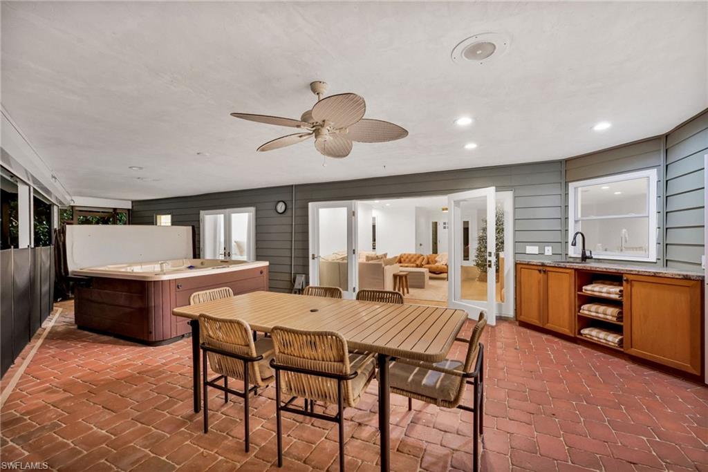 4870 Whispering Pine Way Naples, FL 34103 - Photo 38 of 43 a view of a dining room with furniture window and wooden floor