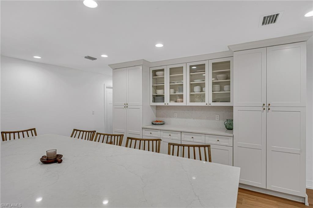 4870 Whispering Pine Way Naples, FL 34103 - Photo 6 of 43 wooden floor in a hall with a window