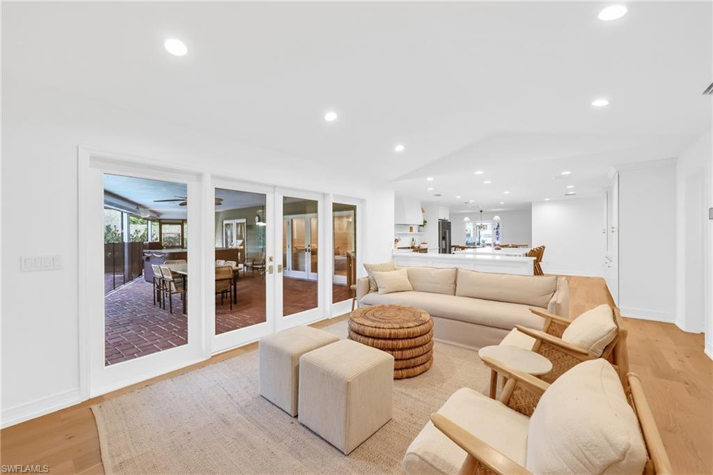 4870 Whispering Pine Way Naples, FL 34103 - Photo 9 of 43 a living room with furniture and a large window