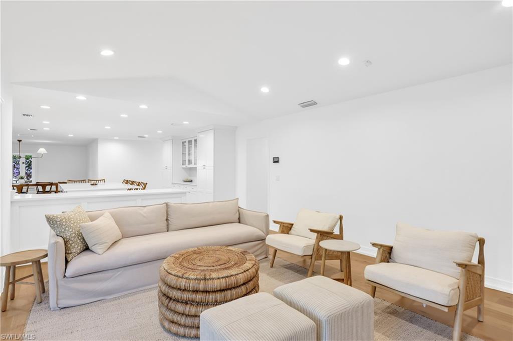 4870 Whispering Pine Way Naples, FL 34103 - Photo 10 of 43 a living room with furniture and a view of kitchen