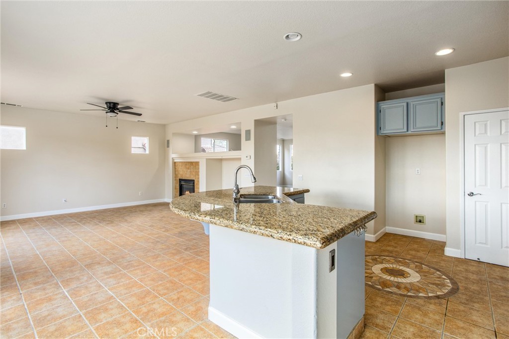 19429 Norwich Drive Riverside, CA 92508 - Photo 17 of 45 a view of kitchen island a sink dishwasher and a refrigerator with wooden floor