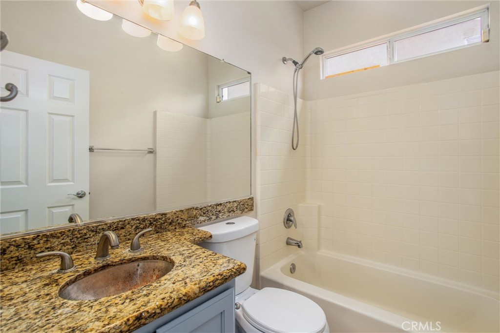 19429 Norwich Drive Riverside, CA 92508 - Photo 22 of 45 a bathroom with a granite countertop sink and a mirror