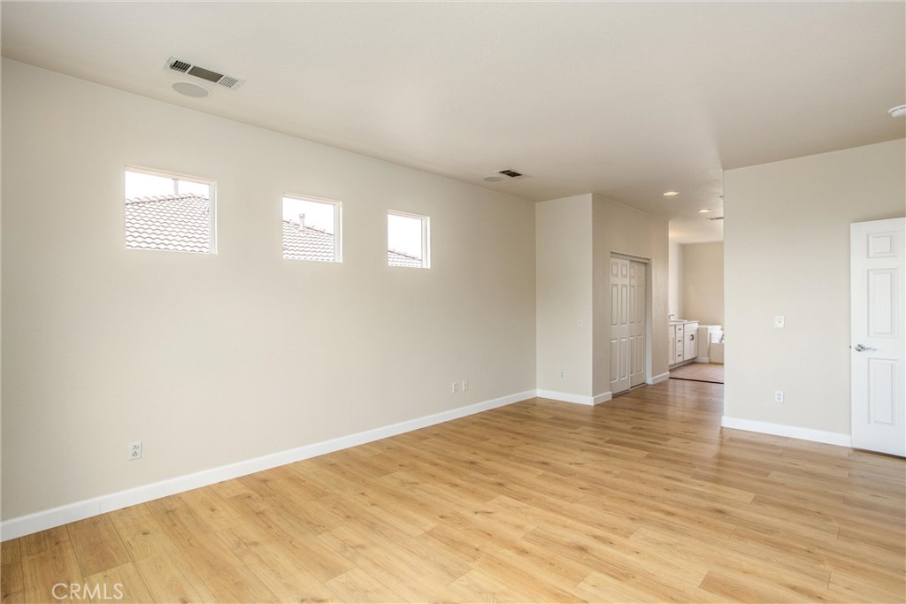 19429 Norwich Drive Riverside, CA 92508 - Photo 24 of 45 a view of an empty room with wooden floor and a window