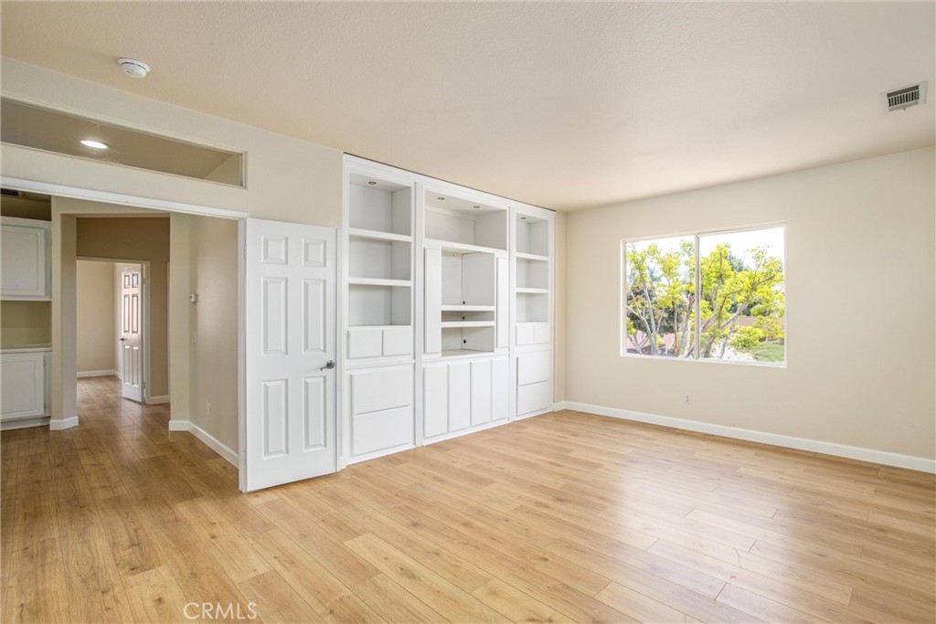 19429 Norwich Drive Riverside, CA 92508 - Photo 27 of 45 an empty room with wooden floor and windows