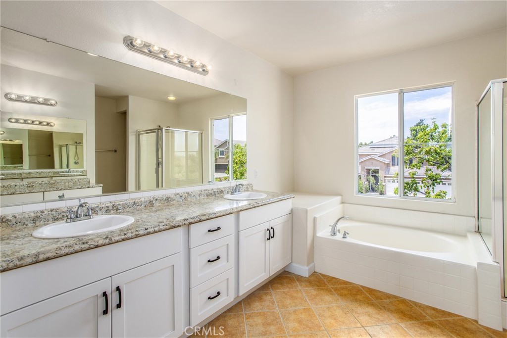 19429 Norwich Drive Riverside, CA 92508 - Photo 28 of 45 a bathroom with a granite countertop tub sink and mirror