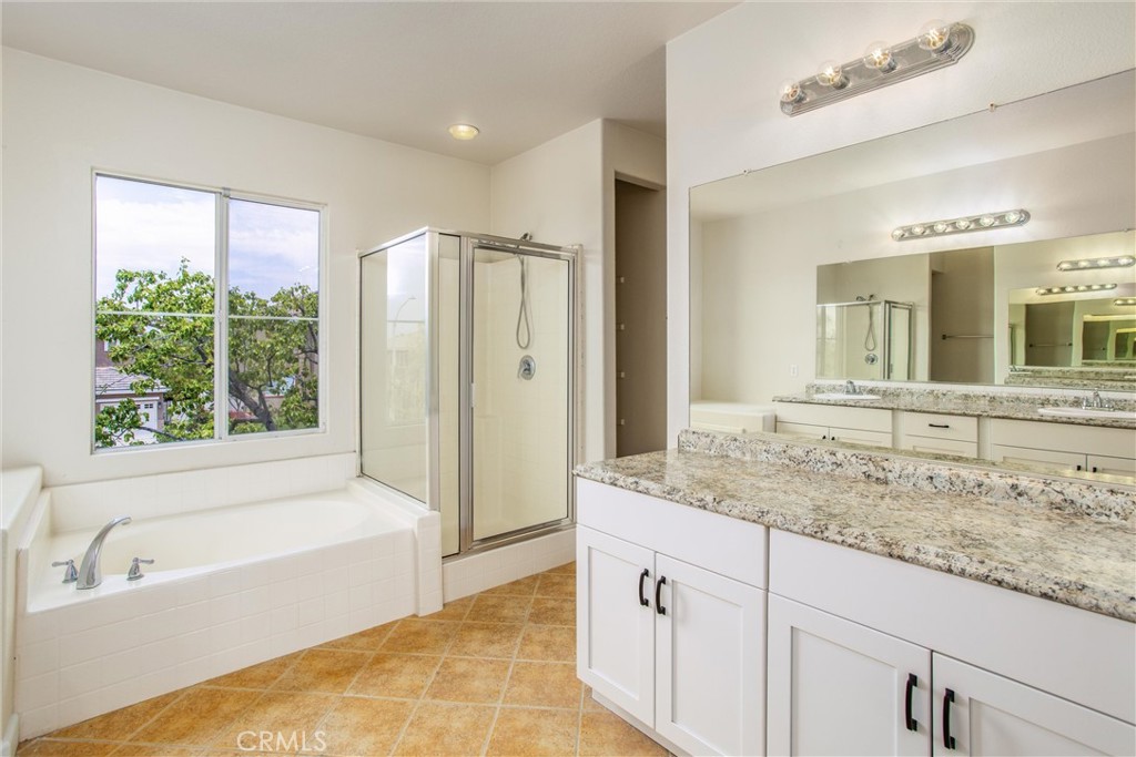 19429 Norwich Drive Riverside, CA 92508 - Photo 29 of 45 a bathroom with a granite countertop tub sink and mirror