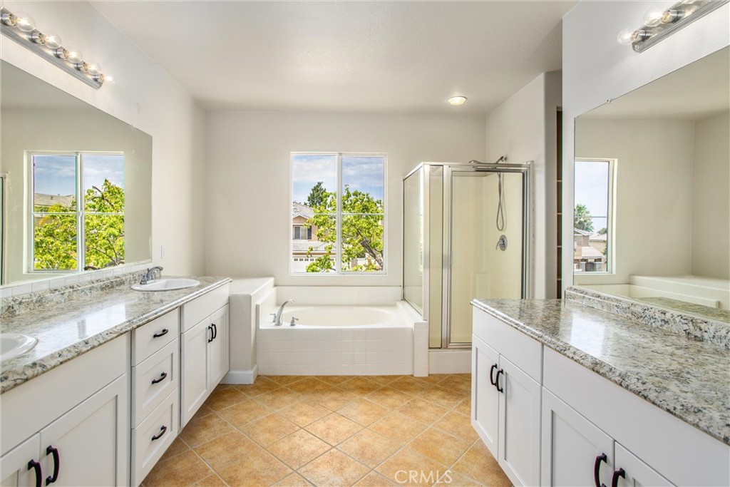 19429 Norwich Drive Riverside, CA 92508 - Photo 30 of 45 a spacious bathroom with a granite countertop tub sink and mirror
