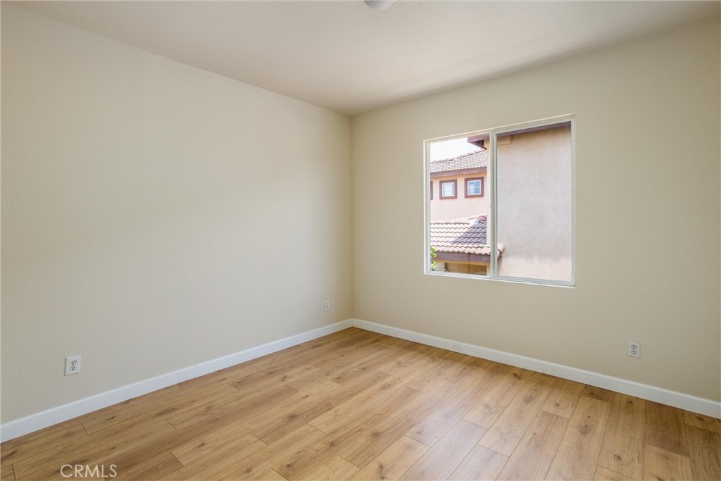 19429 Norwich Drive Riverside, CA 92508 - Photo 35 of 45 a view of an empty room with wooden floor and a window
