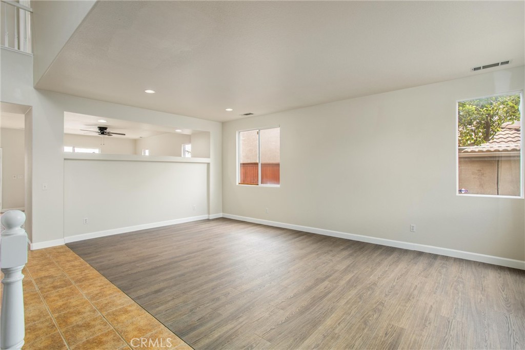 19429 Norwich Drive Riverside, CA 92508 - Photo 4 of 45 an empty room with wooden floor and windows