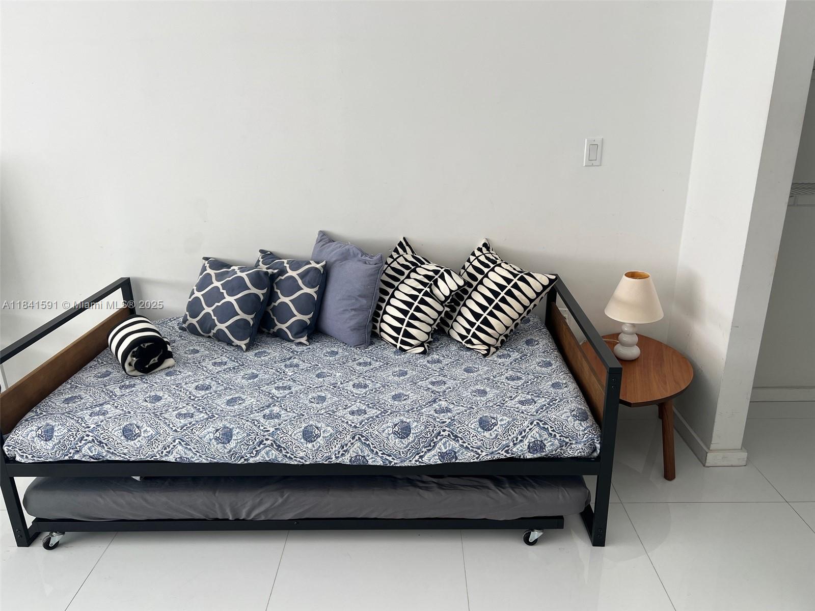 100 Lincoln Road, Unit 1601 Miami Beach, FL 33139 - Photo 11 of 57 a bedroom with a bed and chair