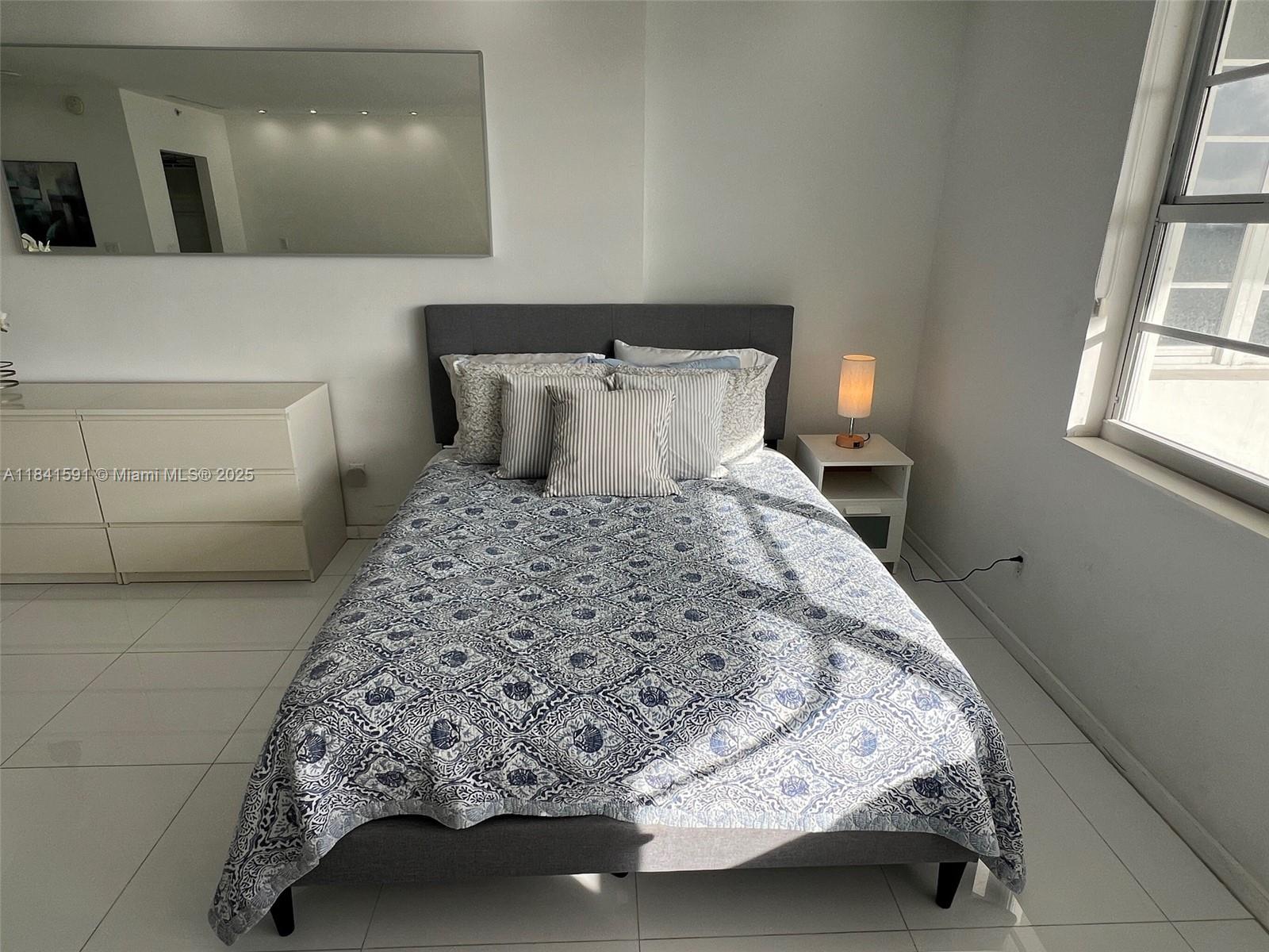 100 Lincoln Road, Unit 1601 Miami Beach, FL 33139 - Photo 12 of 57 a bedroom with a bed and window