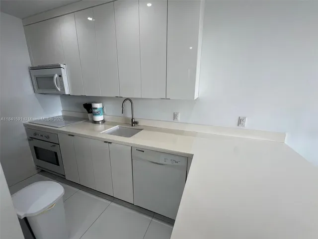 a living room with furniture potted plant and a wooden floor