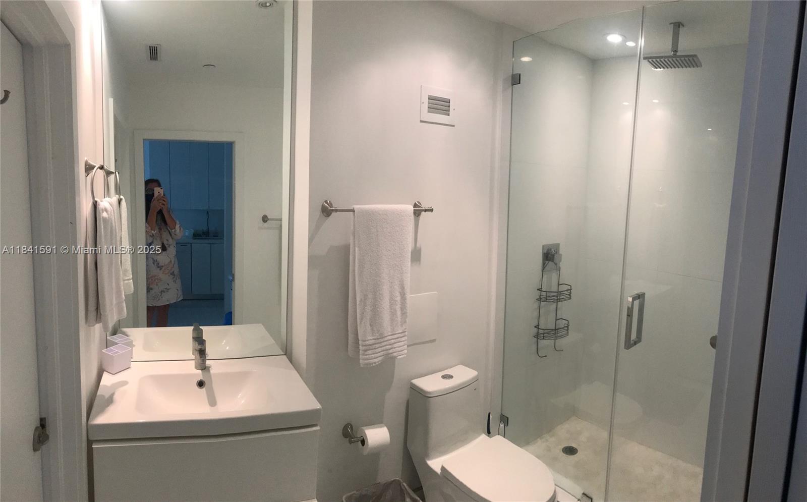 100 Lincoln Road, Unit 1601 Miami Beach, FL 33139 - Photo 19 of 57 a bathroom with a toilet sink shower and mirror