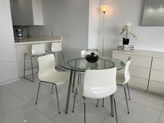 a dining room with furniture and a chandelier