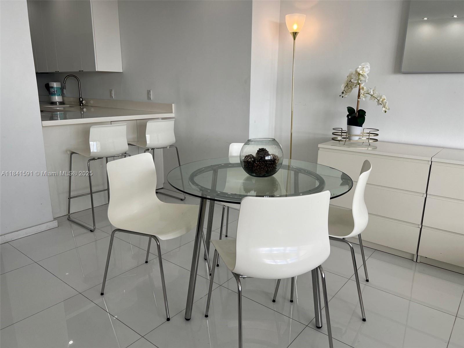 100 Lincoln Road, Unit 1601 Miami Beach, FL 33139 - Photo 3 of 57 a kitchen with a table and chairs in it