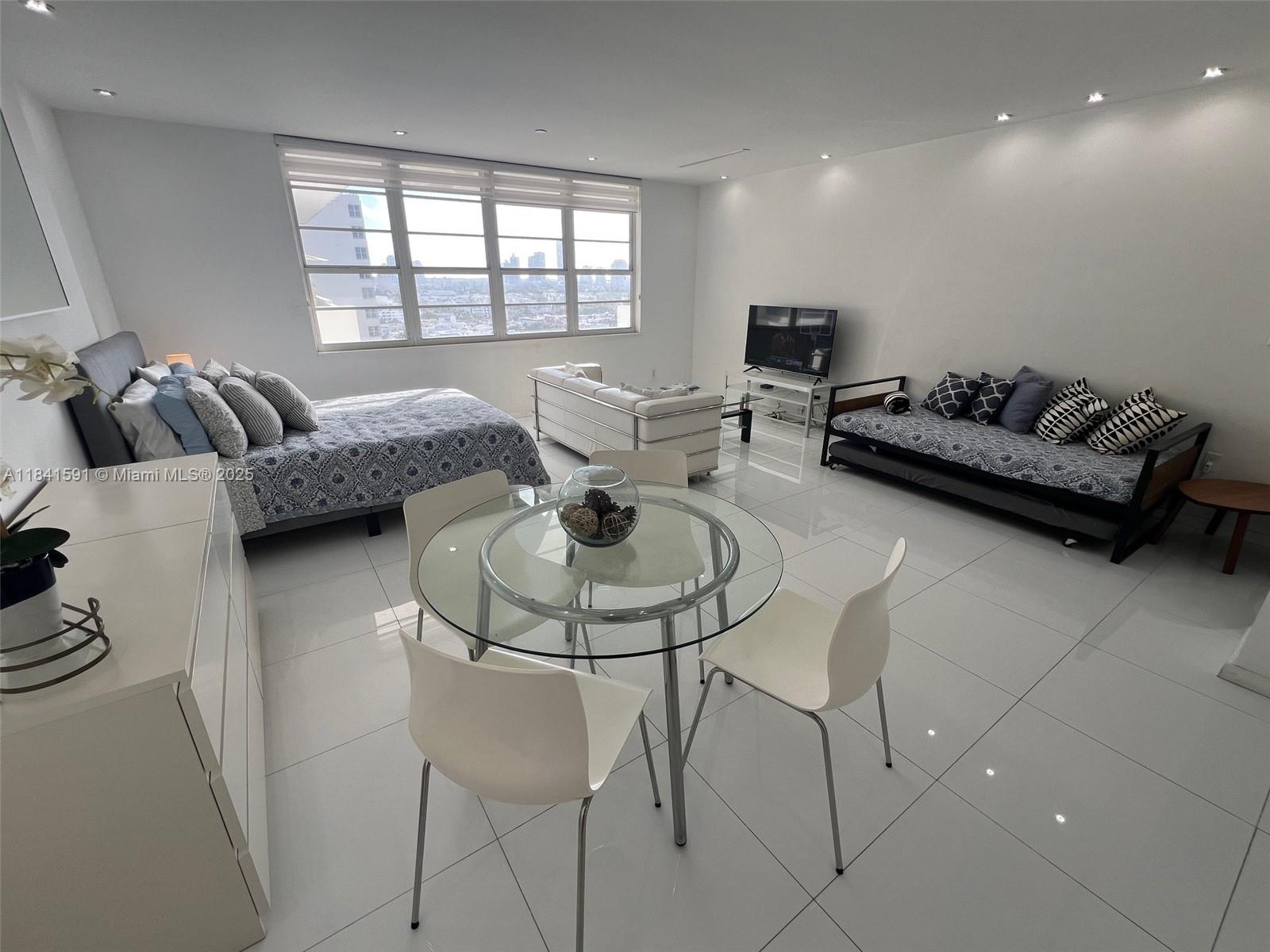 100 Lincoln Road, Unit 1601 Miami Beach, FL 33139 - Photo 4 of 57 a living room with furniture and a large window