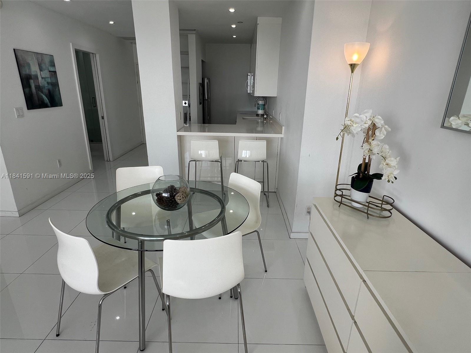 100 Lincoln Road, Unit 1601 Miami Beach, FL 33139 - Photo 5 of 57 a dining room with furniture and a chandelier