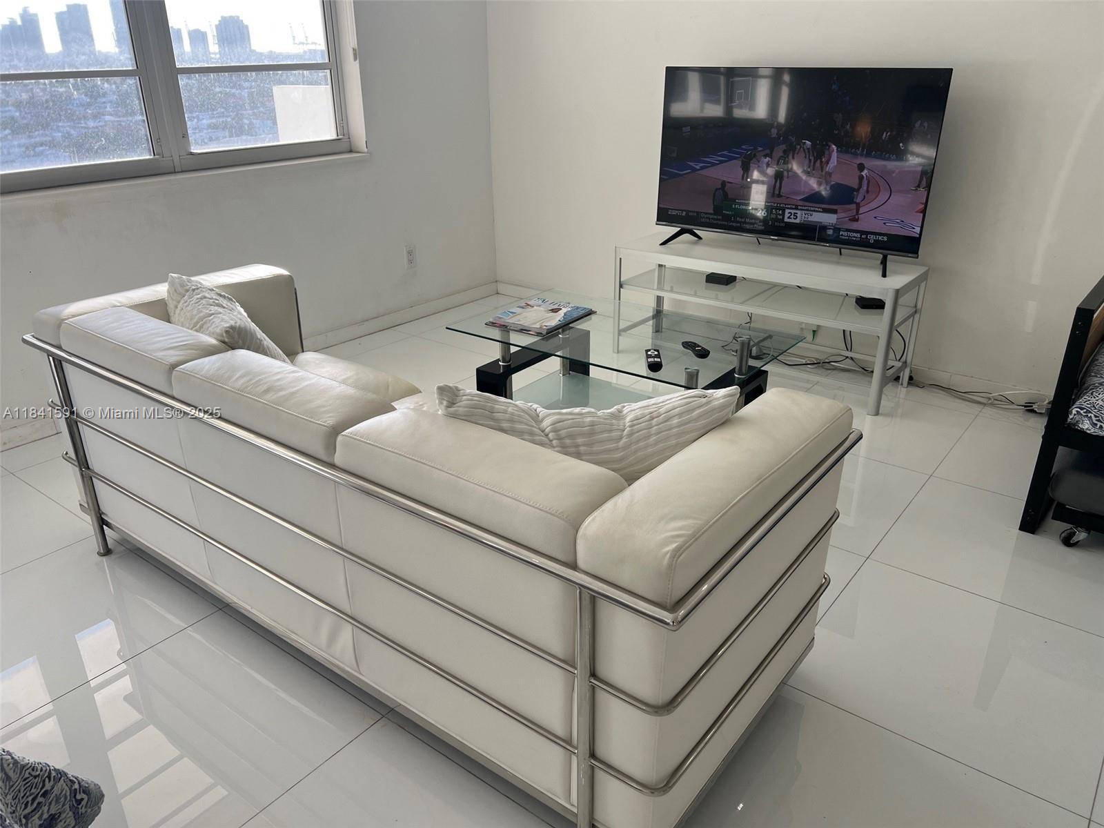 100 Lincoln Road, Unit 1601 Miami Beach, FL 33139 - Photo 6 of 57 a living room with furniture and a flat screen tv