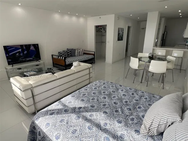 a bedroom with a bed and chair