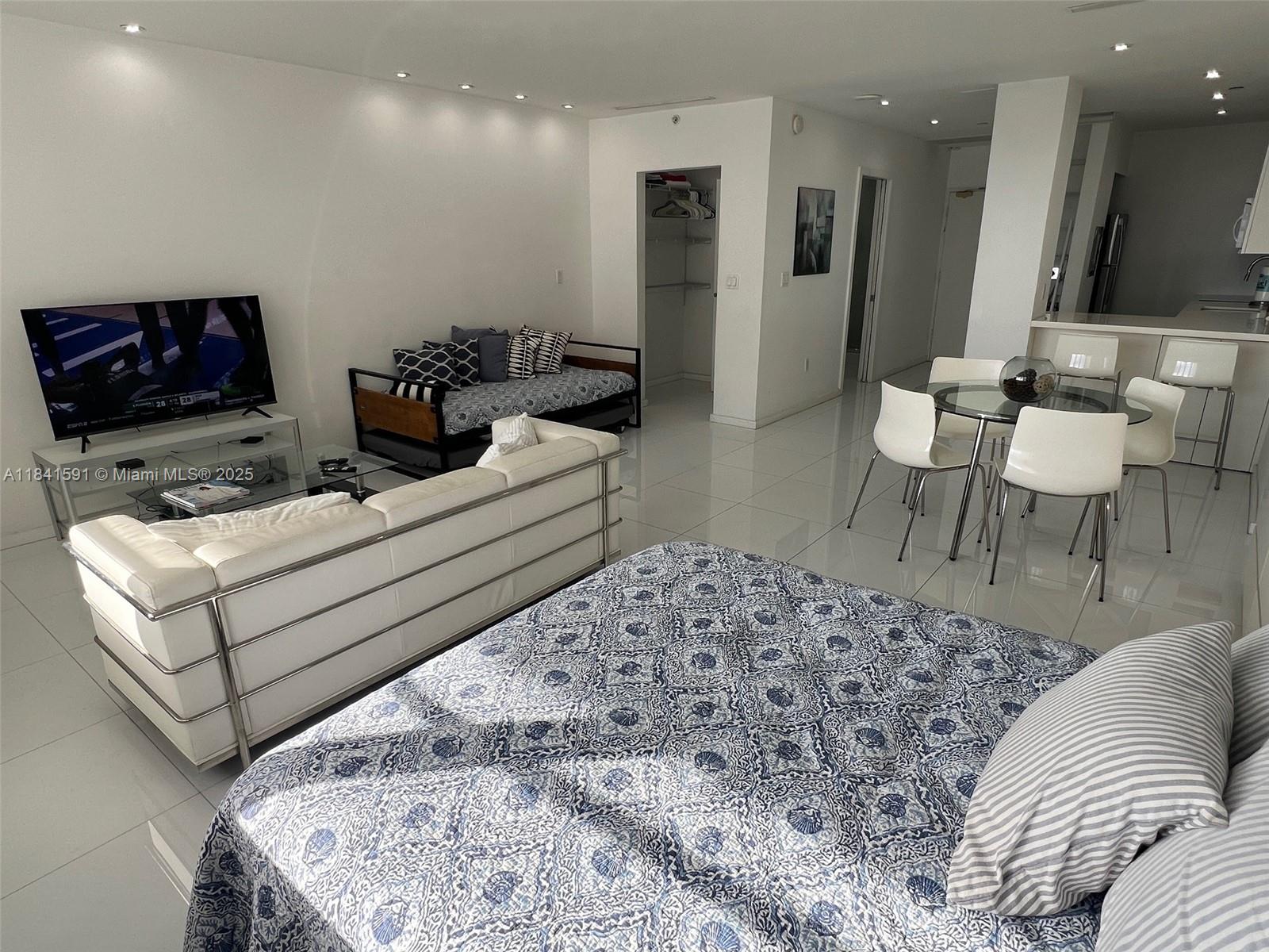 100 Lincoln Road, Unit 1601 Miami Beach, FL 33139 - Photo 8 of 57 a living room with furniture and a flat screen tv