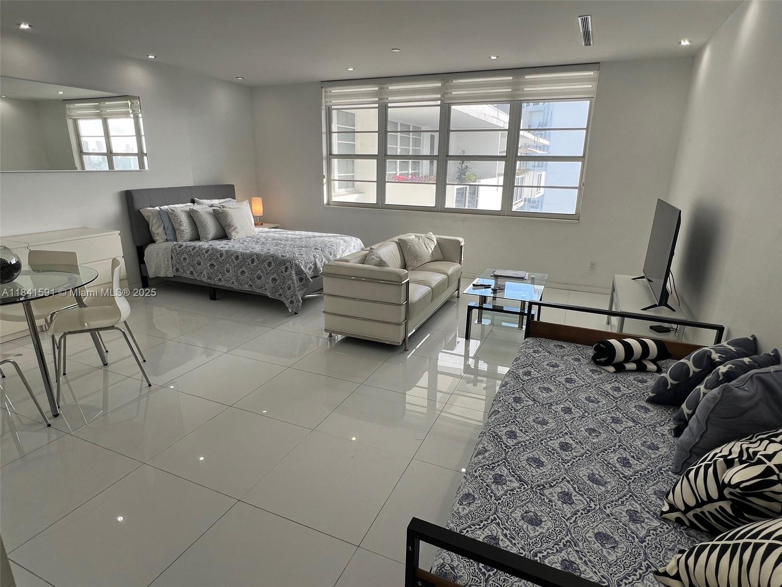 100 Lincoln Road, Unit 1601 Miami Beach, FL 33139 - Photo 10 of 57 a living room with furniture and a window