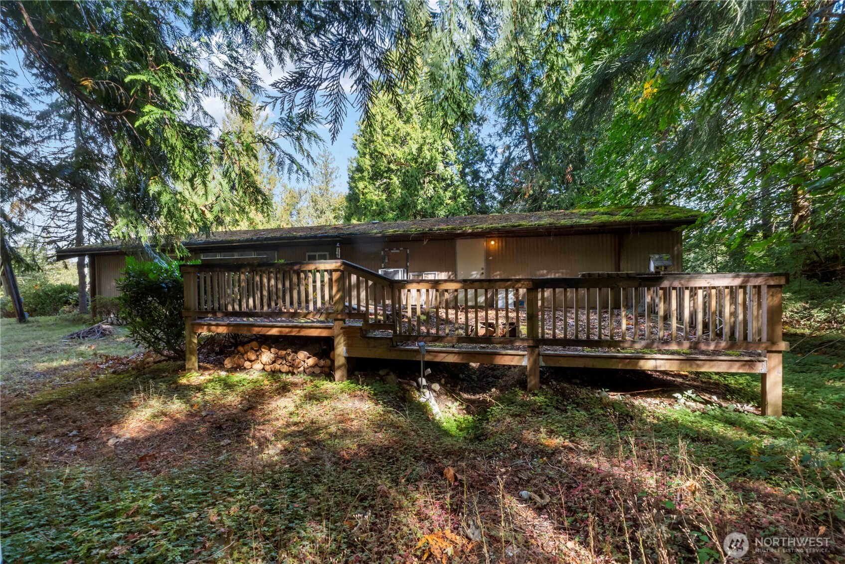 5128 335th Lane Southeast Fall City, WA 98024 - Photo 16 of 36 a view of a small yard in front of a house with wooden deck