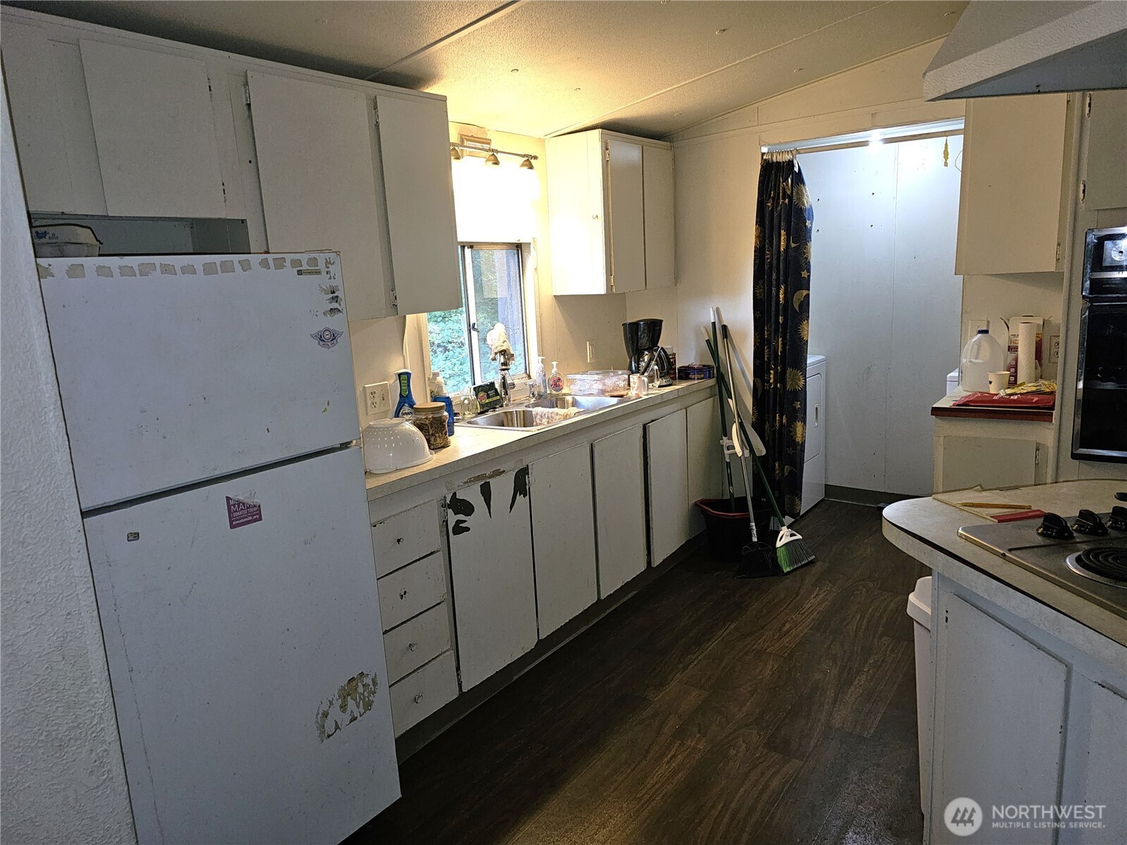 5128 335th Lane Southeast Fall City, WA 98024 - Photo 24 of 36 a kitchen with refrigerator a stove a sink dishwasher and cabinets with wooden floor