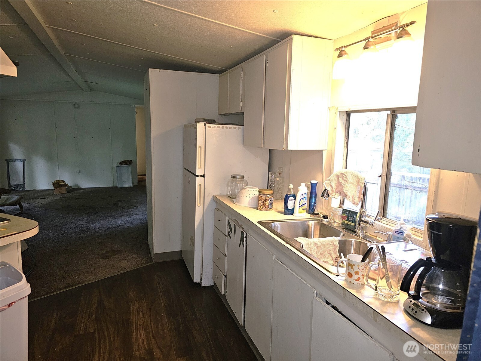 5128 335th Lane Southeast Fall City, WA 98024 - Photo 25 of 36 a kitchen with a sink a refrigerator and a stove top oven