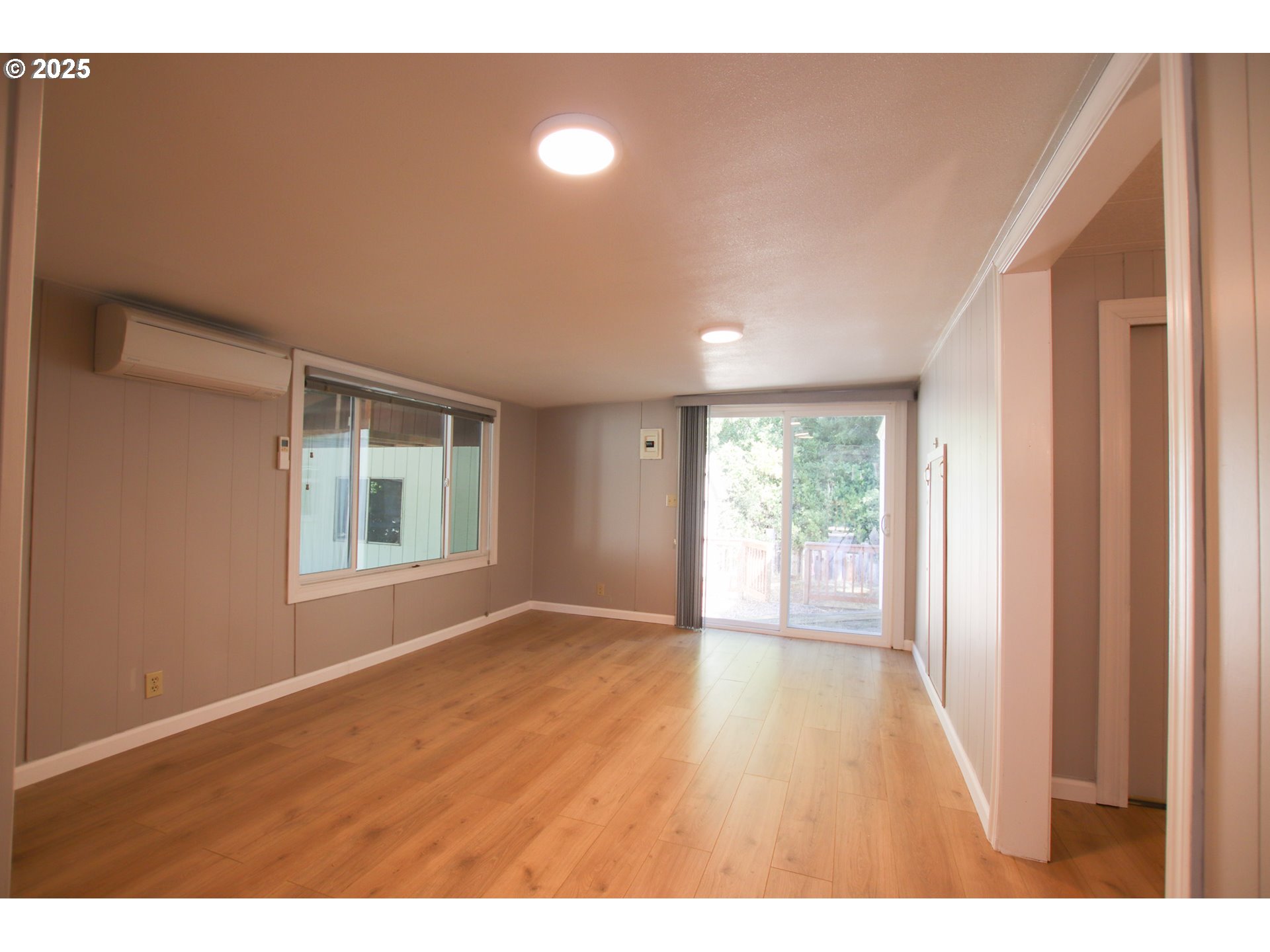 1600 Rhododendron Drive, Unit 279 Florence, OR 97439 - Photo 13 of 30 a view of empty room with wooden floor and fan