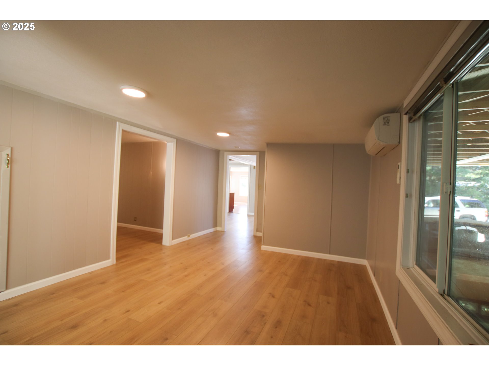 1600 Rhododendron Drive, Unit 279 Florence, OR 97439 - Photo 14 of 30 a view of an empty room with wooden floor and a window