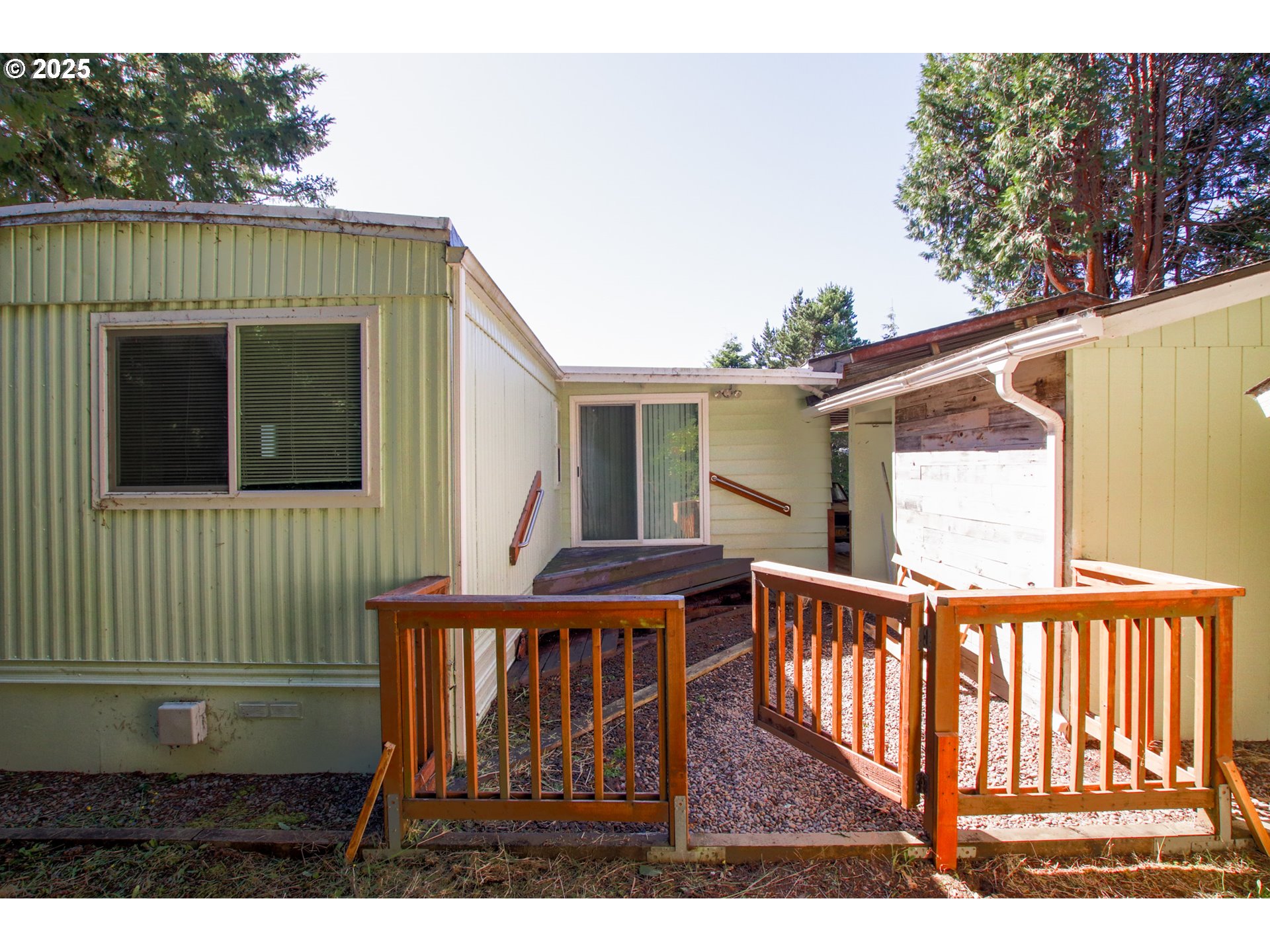 1600 Rhododendron Drive, Unit 279 Florence, OR 97439 - Photo 25 of 30 a view of a house with wooden deck and furniture