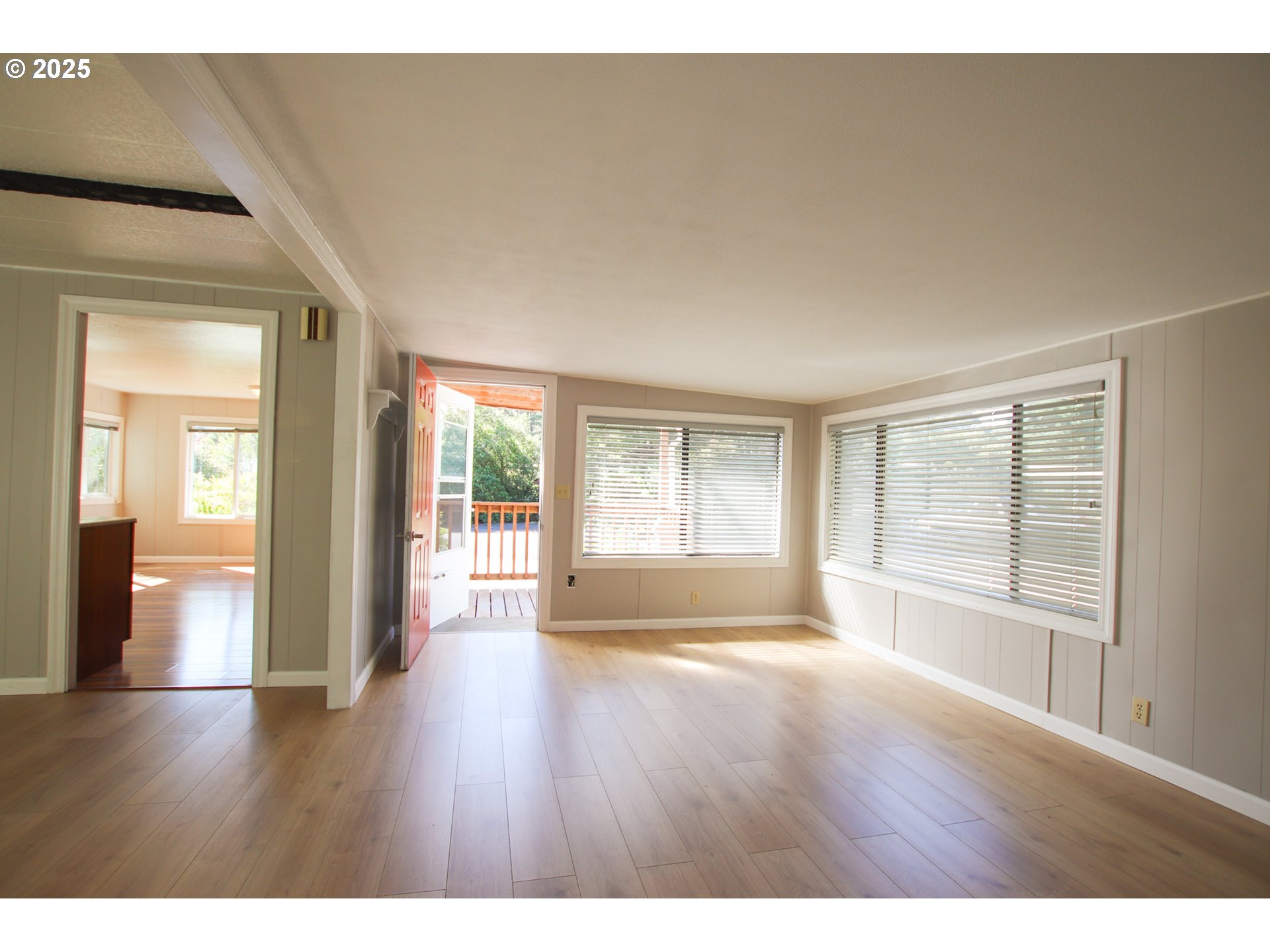 1600 Rhododendron Drive, Unit 279 Florence, OR 97439 - Photo 7 of 30 a view of an empty room with wooden floor and a window