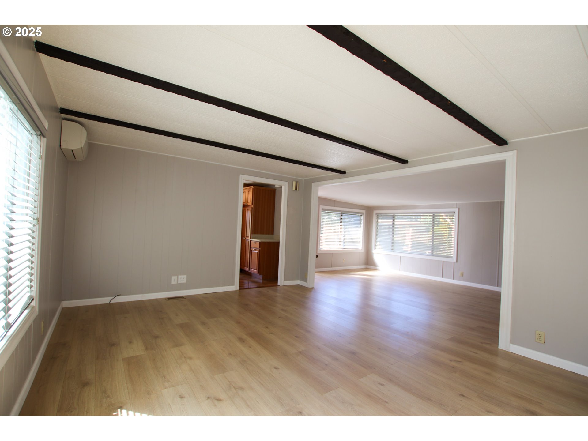 1600 Rhododendron Drive, Unit 279 Florence, OR 97439 - Photo 9 of 30 a view of an empty room with wooden floor and a window