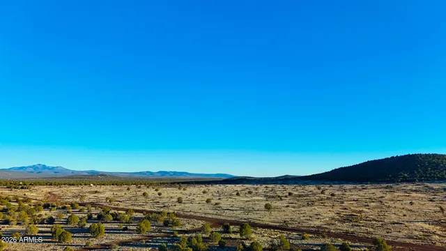 a view of ocean with a large mountain